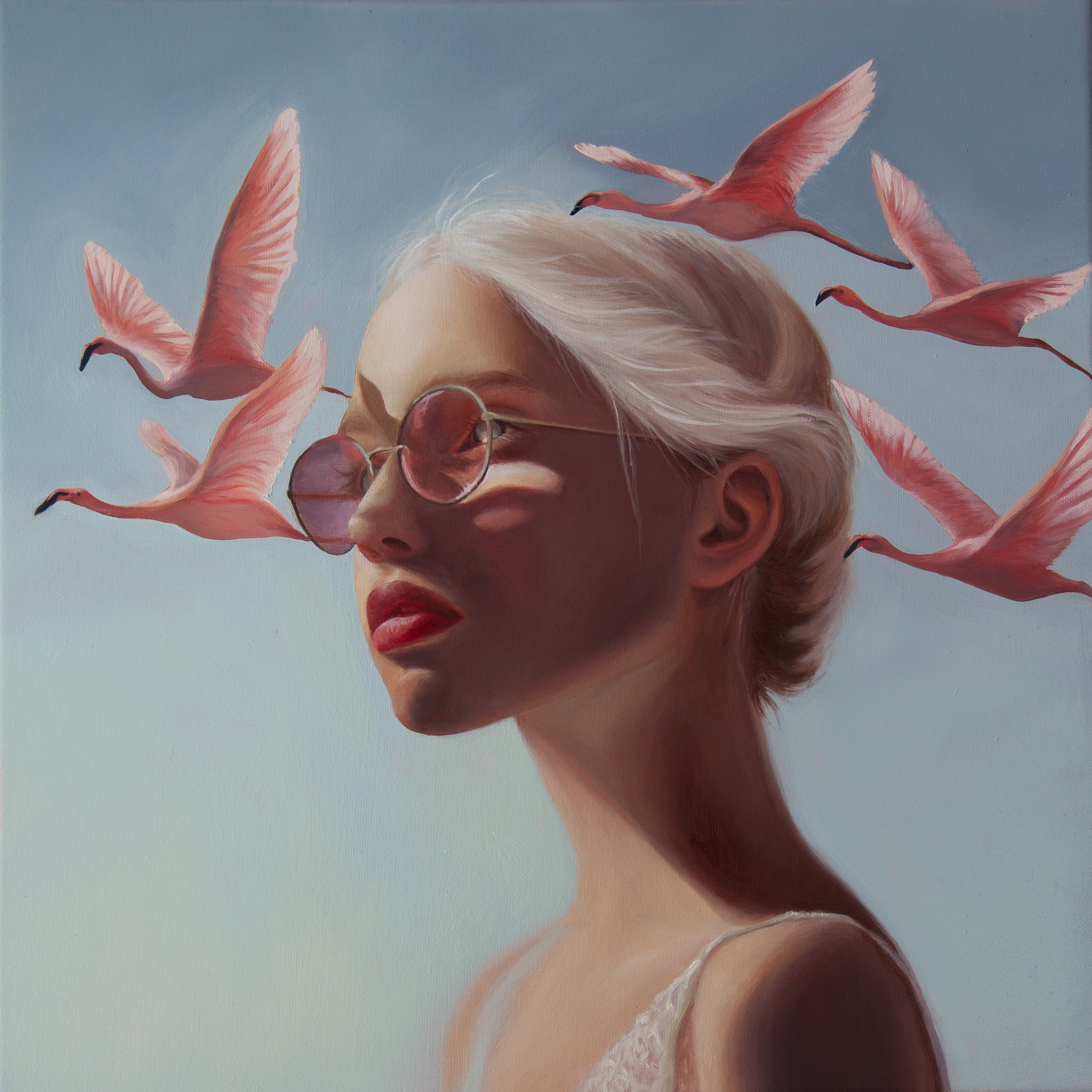 Oil painting by Kareen Kalush of A surreal portrait painting of a woman in profile with platinum-blonde hair, round tinted sunglasses, and several pink flamingos flying around her against a pale blue sky.